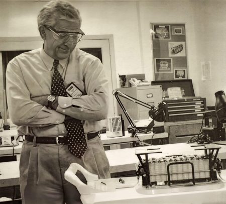 Bill B. of TRW with a notable grin while inspecting a 9 Ah Super NiCd battery during a September 1993 buy-off at EPT.