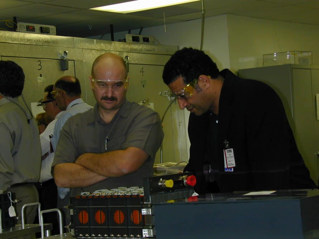 Two Customers Admiring Gravity Probe B Battery during Final Acceptance Nov 30, 2001 - Several Others Examining the Environmental Test Chamber